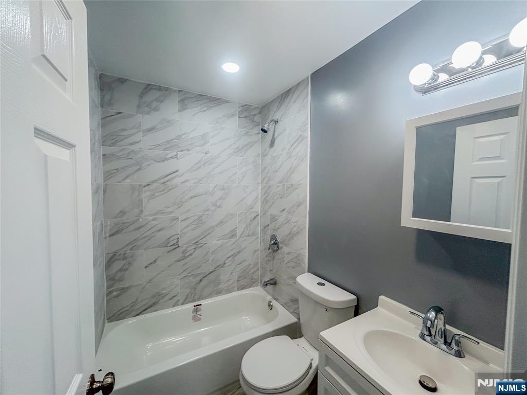 676 South 20th Street Newark, NJ 07103 - Photo 18 of 38 a bathroom with a toilet sink vanity tub and shower
