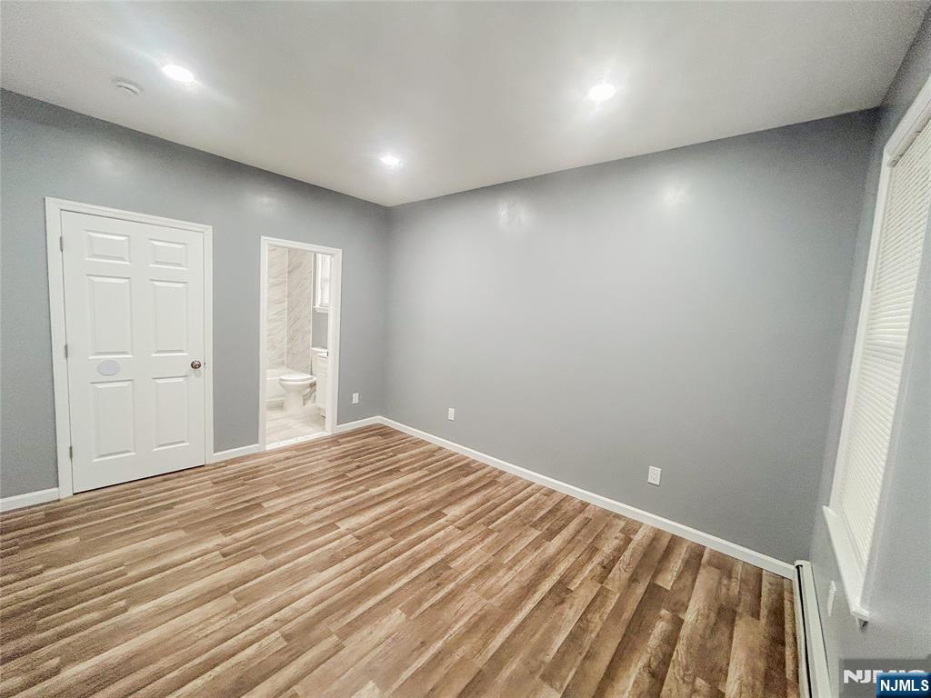 676 South 20th Street Newark, NJ 07103 - Photo 21 of 38 a view of room with wooden floor