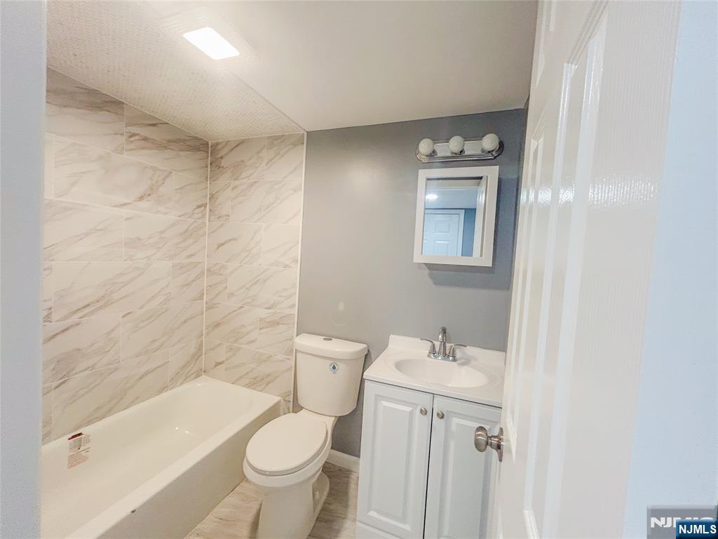 676 South 20th Street Newark, NJ 07103 - Photo 26 of 38 a bathroom with a sink a toilet and shower