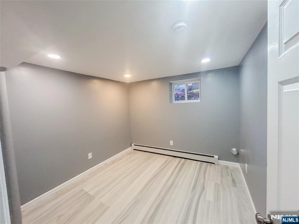 676 South 20th Street Newark, NJ 07103 - Photo 29 of 38 an empty room with a bench