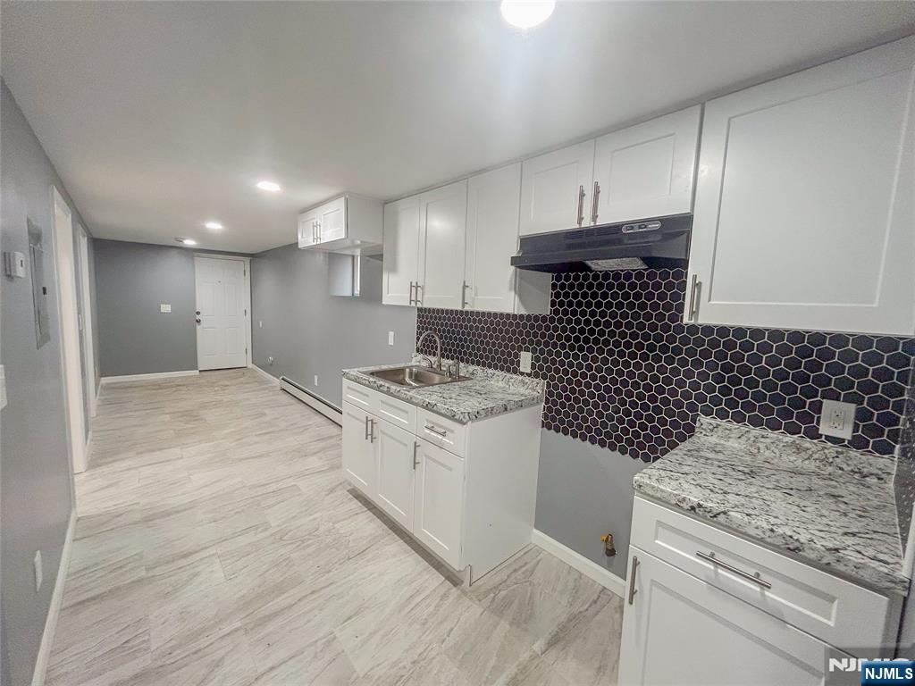 676 South 20th Street Newark, NJ 07103 - Photo 32 of 38 a kitchen with a stove and a sink