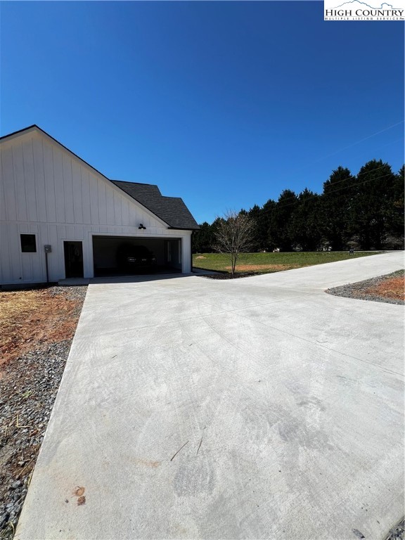 3991 Poplar Springs Road Elkin, NC 28621 - Photo 3 of 45 a view of white house with a yard