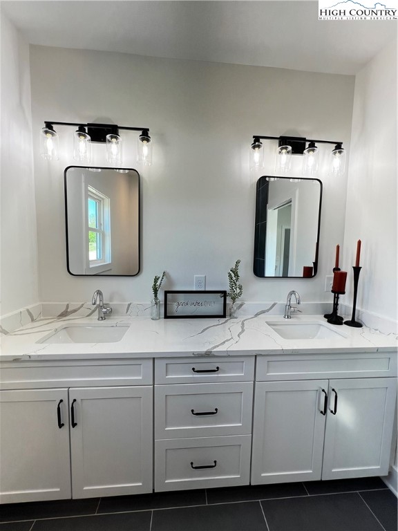 3991 Poplar Springs Road Elkin, NC 28621 - Photo 35 of 45 a bathroom with a double vanity sink and a mirror