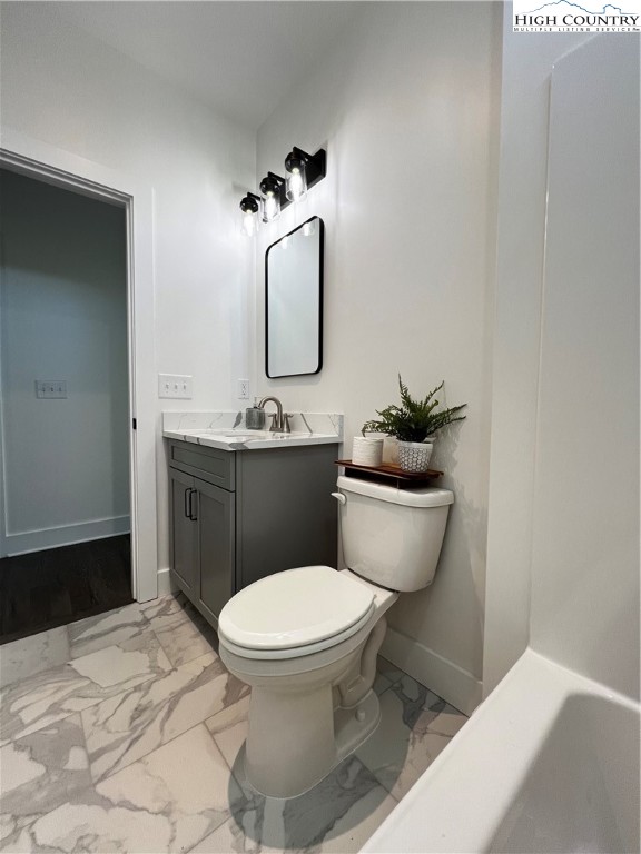 3991 Poplar Springs Road Elkin, NC 28621 - Photo 41 of 45 a bathroom with a toilet sink and mirror