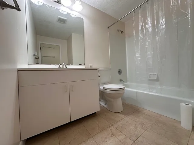 a bathroom with a toilet a sink and bathtub