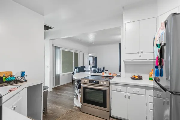 a kitchen with a sink stove and cabinets