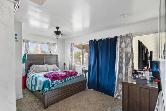 a bedroom with a bed and a flat screen tv