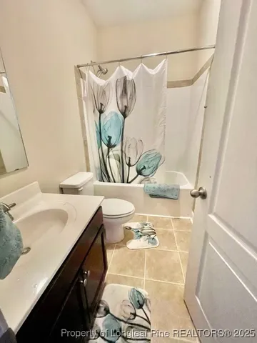 a spacious bathroom with a sink a mirror and a shower