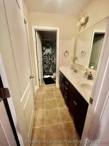 a bathroom with a toilet and a shower curtain