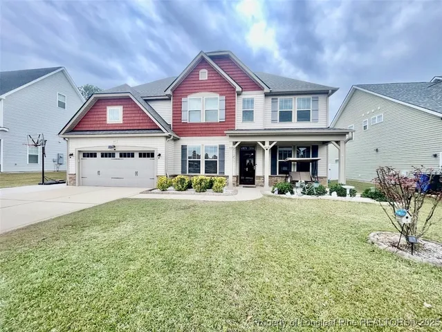 a front view of a house with a yard and porch
