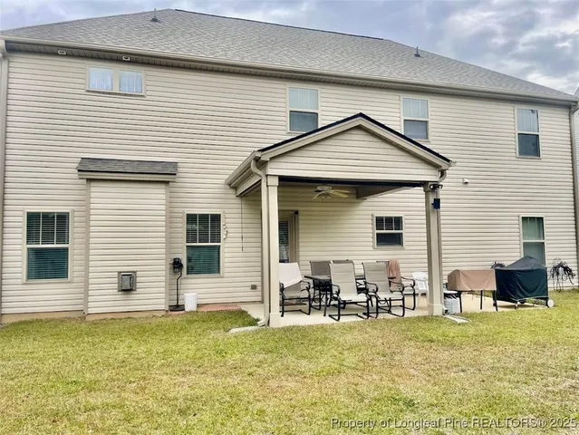 a swimming pool with some trees and wooden fence