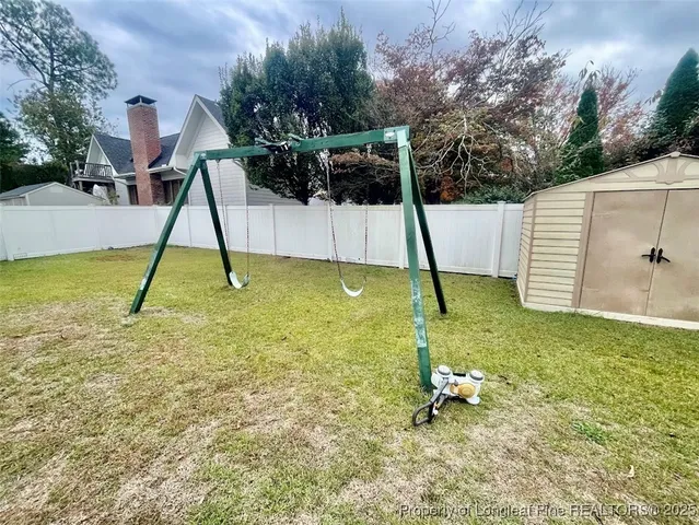 a swimming pool with yard and outdoor seating