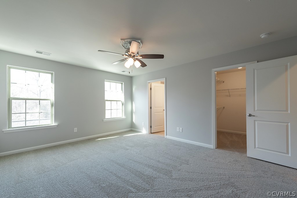 5613 Riverside Heights Way Richmond, VA 23225 - Photo 20 of 41 an empty room with chandelier fan and windows