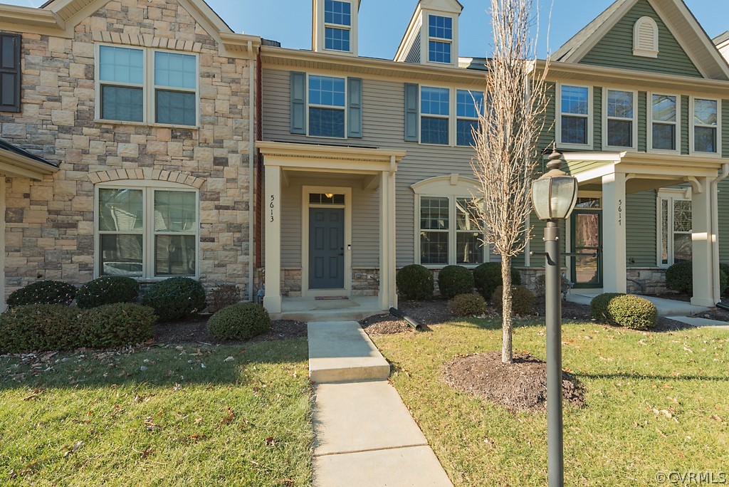 5613 Riverside Heights Way Richmond, VA 23225 - Photo 2 of 41 a view of a brick house with many windows