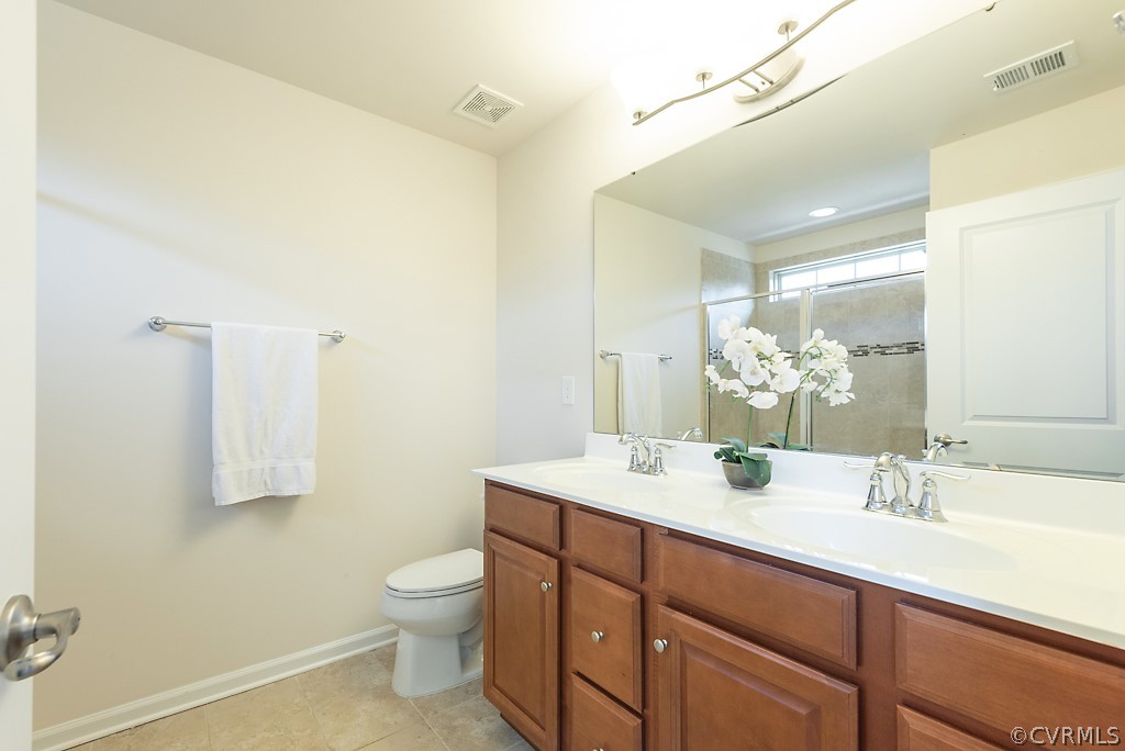 5613 Riverside Heights Way Richmond, VA 23225 - Photo 23 of 41 a bathroom with a granite countertop sink a toilet and a mirror