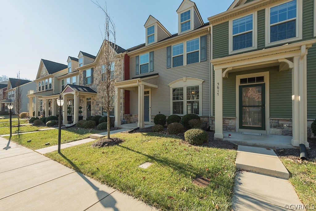 5613 Riverside Heights Way Richmond, VA 23225 - Photo 41 of 41 a view of a brick house with many windows