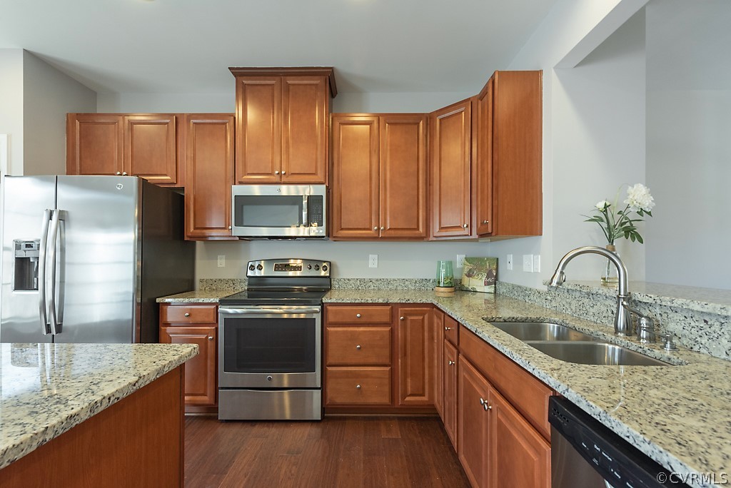 5613 Riverside Heights Way Richmond, VA 23225 - Photo 9 of 41 a kitchen with stainless steel appliances granite countertop a sink stove and refrigerator