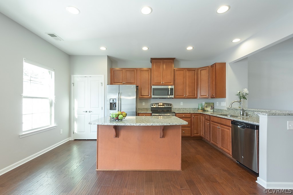 5613 Riverside Heights Way Richmond, VA 23225 - Photo 10 of 41 a kitchen with stainless steel appliances granite countertop a stove top oven a sink dishwasher and a refrigerator
