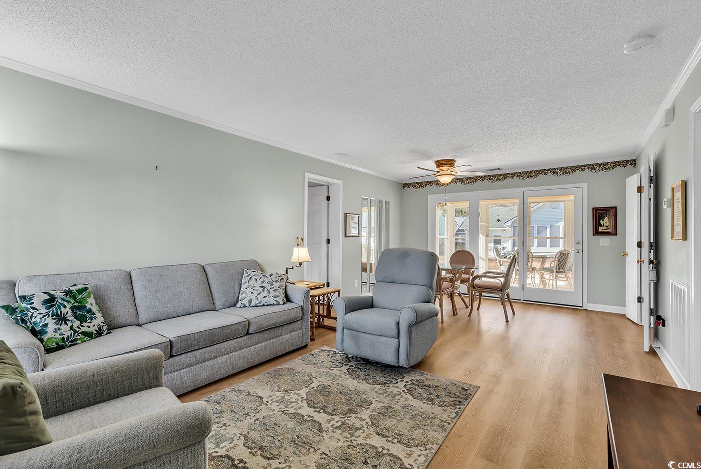 9467 Old Palmetto Road Murrells Inlet, SC 29576 - Photo 6 of 38 Living room featuring ceiling fan, ornamental mold