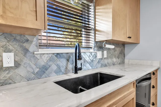 a kitchen with a sink and cabinets