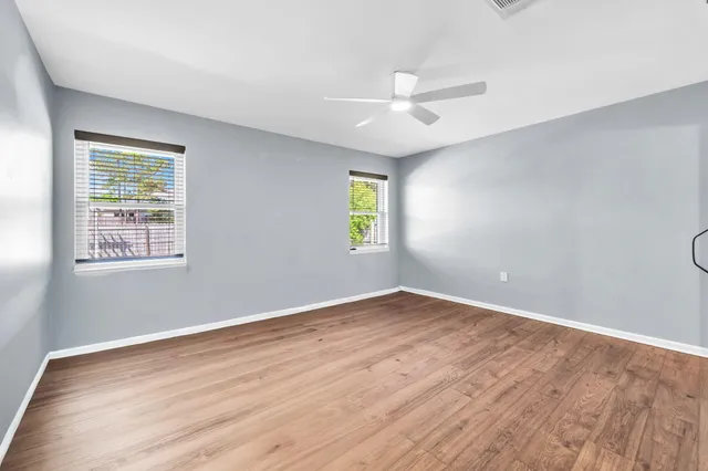 a view of an empty room and wooden floor