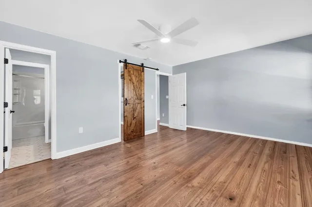a bathroom with a granite countertop sink a mirror and a bathtub
