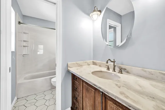 a view of a backyard with a garden and tree