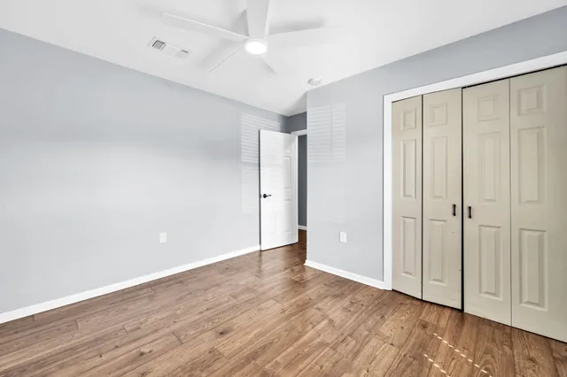 a view of a livingroom with a ceiling fan and window