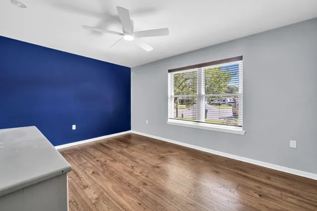 a view of an empty room and wooden floor
