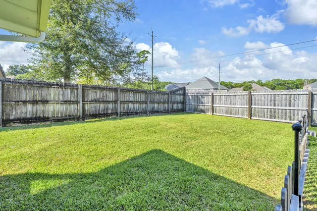 a view of a swimming pool and a yard