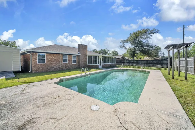 a view of a backyard with a garden and deck