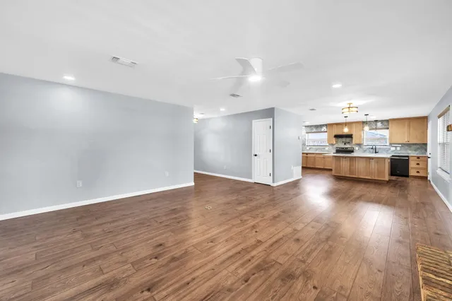 a kitchen with stainless steel appliances a sink stove and cabinets
