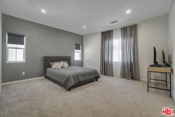 a spacious bedroom with a bed and with furniture