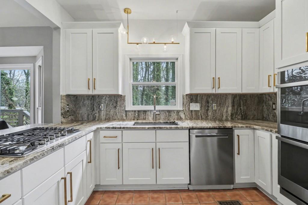 3793 Market Crescent Clarkston, GA 30021 - Photo 18 of 35 a kitchen with stainless steel appliances granite countertop a sink stove and cabinets