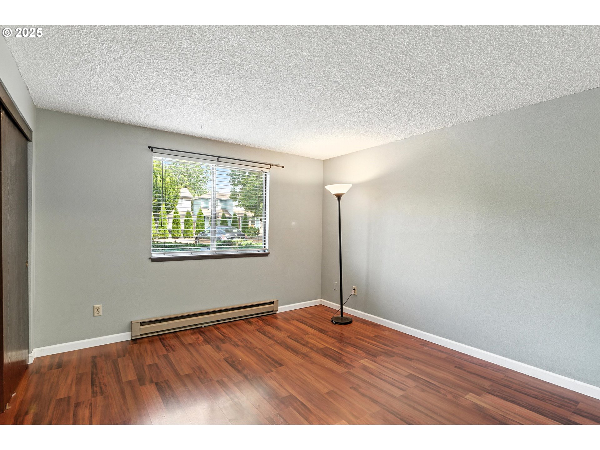 3404 19th Avenue, Unit 117 Forest Grove, OR 97116 - Photo 15 of 18 an empty room with wooden floor and windows