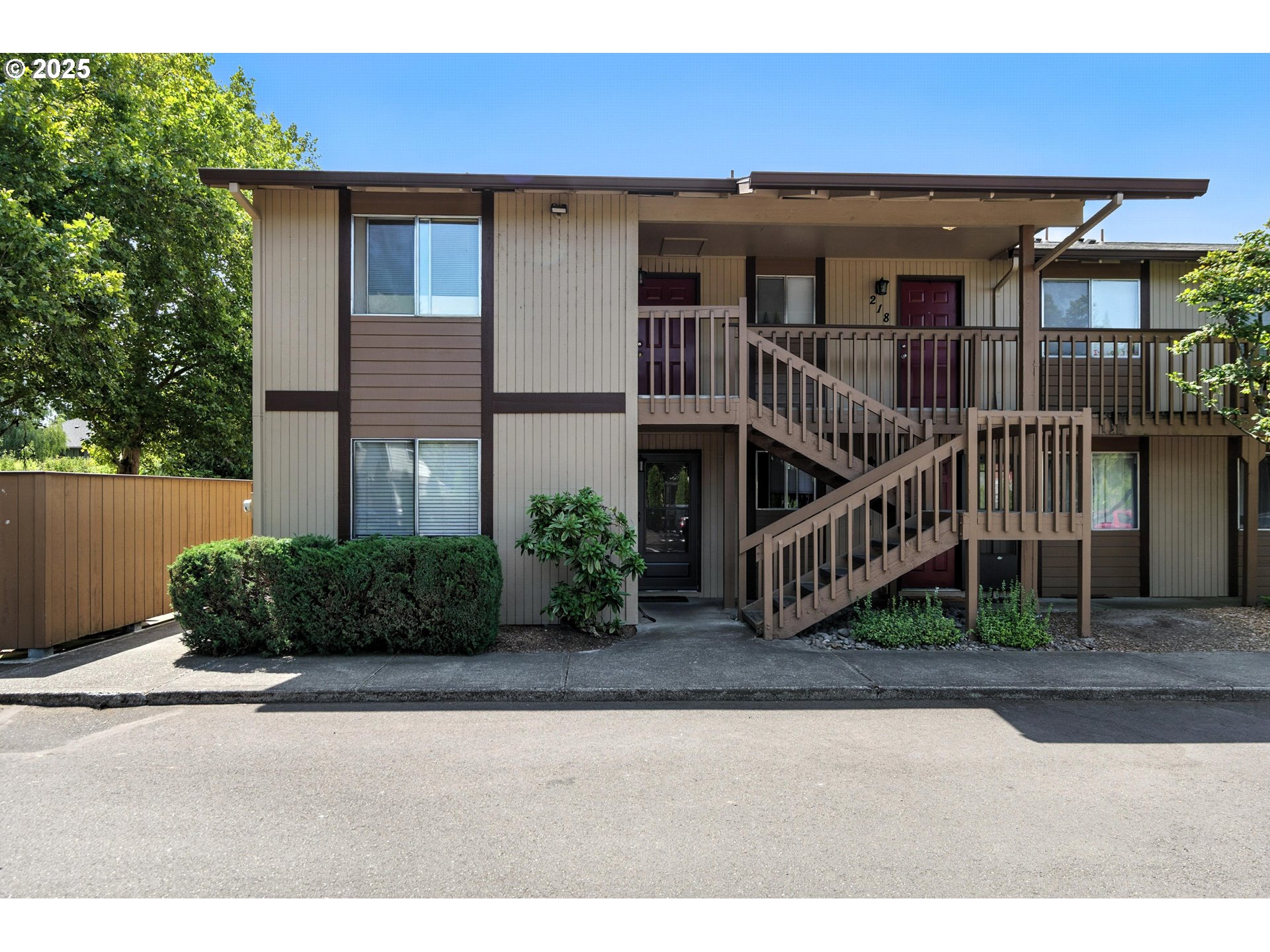 3404 19th Avenue, Unit 117 Forest Grove, OR 97116 - Photo 17 of 18 a view of a house with brick walls plants and a small yard