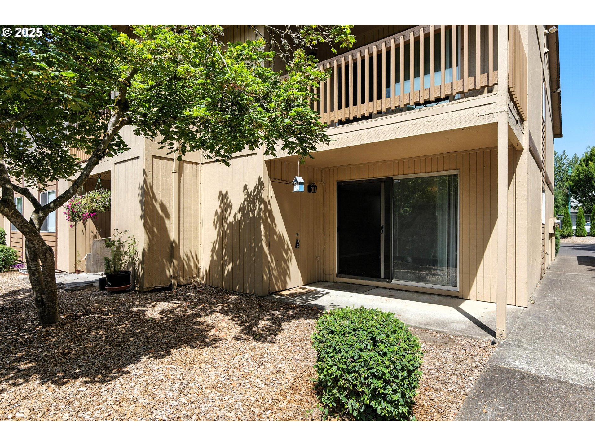 3404 19th Avenue, Unit 117 Forest Grove, OR 97116 - Photo 3 of 18 a black and white building with trees in the background