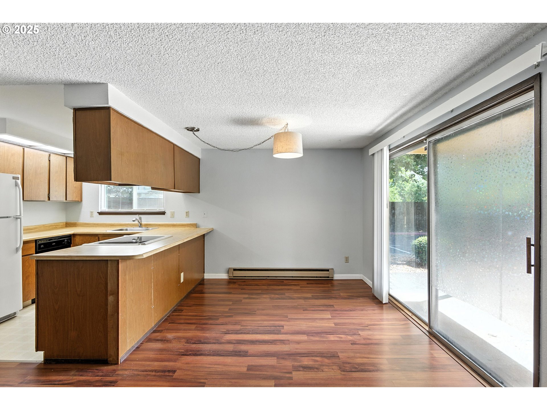 3404 19th Avenue, Unit 117 Forest Grove, OR 97116 - Photo 5 of 18 a kitchen with stainless steel appliances granite countertop a sink stove and wooden floor