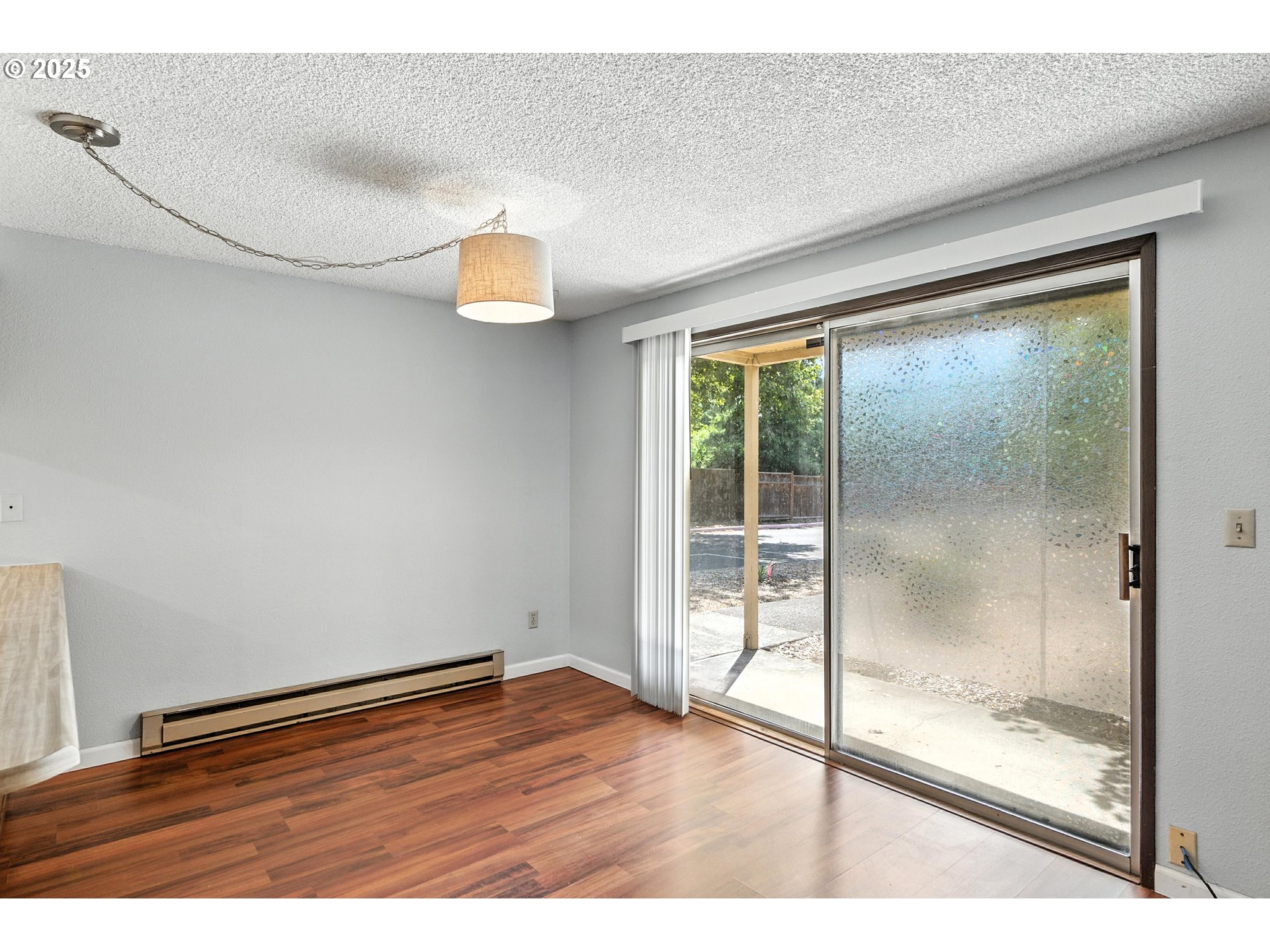 3404 19th Avenue, Unit 117 Forest Grove, OR 97116 - Photo 6 of 18 a view of empty room with wooden floor and fan