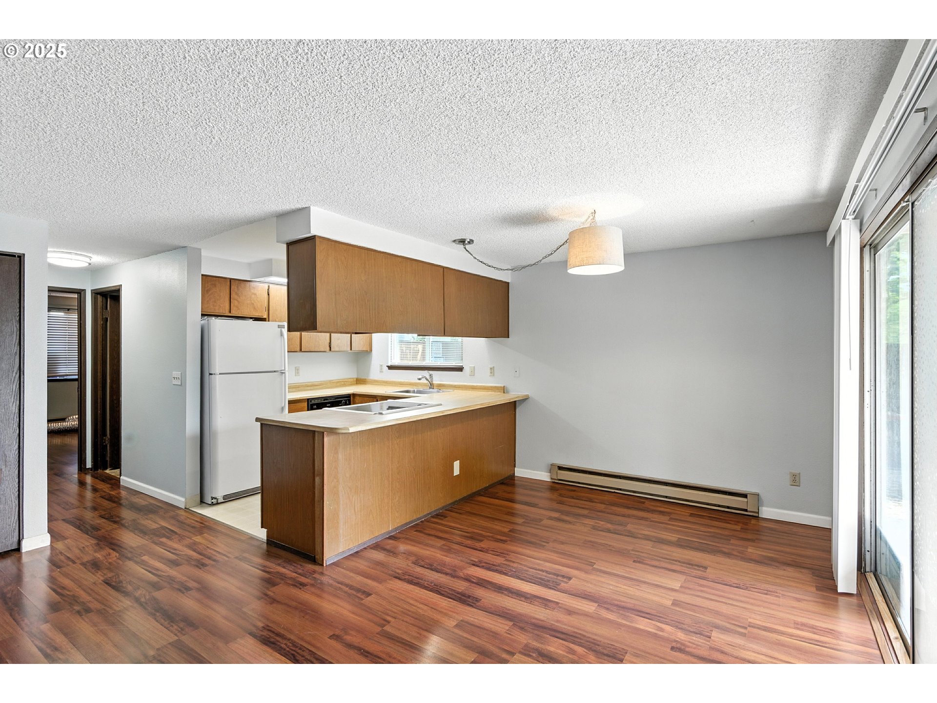 3404 19th Avenue, Unit 117 Forest Grove, OR 97116 - Photo 7 of 18 a kitchen with stainless steel appliances granite countertop a sink a stove a refrigerator and a microwave