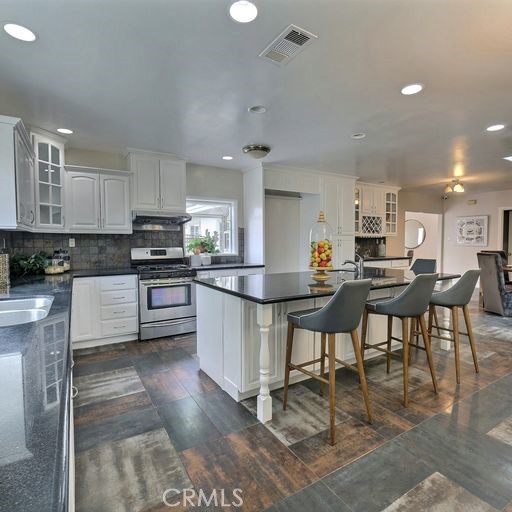 a kitchen with stainless steel appliances kitchen island granite countertop lots of counter top space and furniture