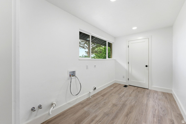 871 Bonita Way Centerville, UT 84014 - Photo 11 of 61 Dedicated utility space featuring wood-finish flooring, crisp white walls, and a recessed lighting package