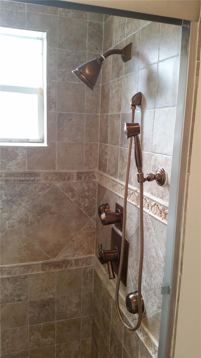 11071 Southwest 11th Place, Unit 124 Davie, FL 33324 - Photo 13 of 18 a bathroom with a shower