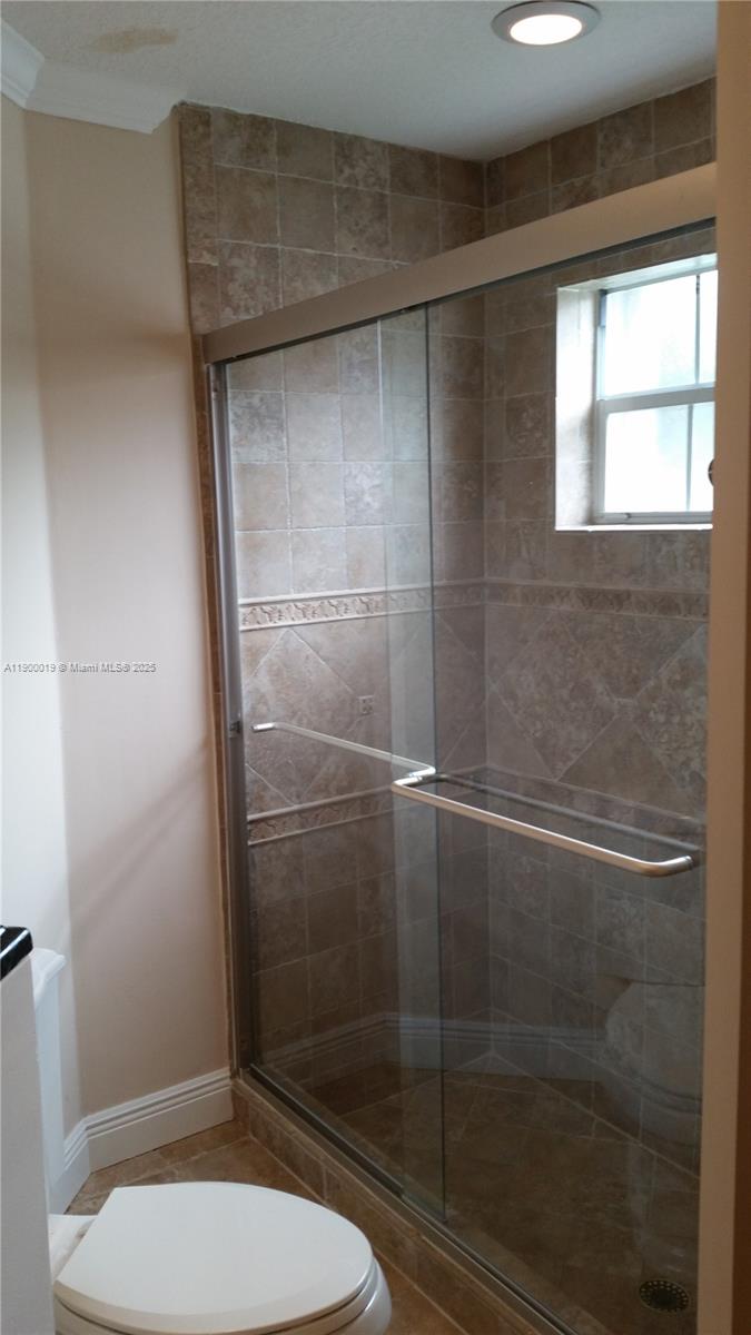 11071 Southwest 11th Place, Unit 124 Davie, FL 33324 - Photo 14 of 18 a bathroom with a toilet and a shower