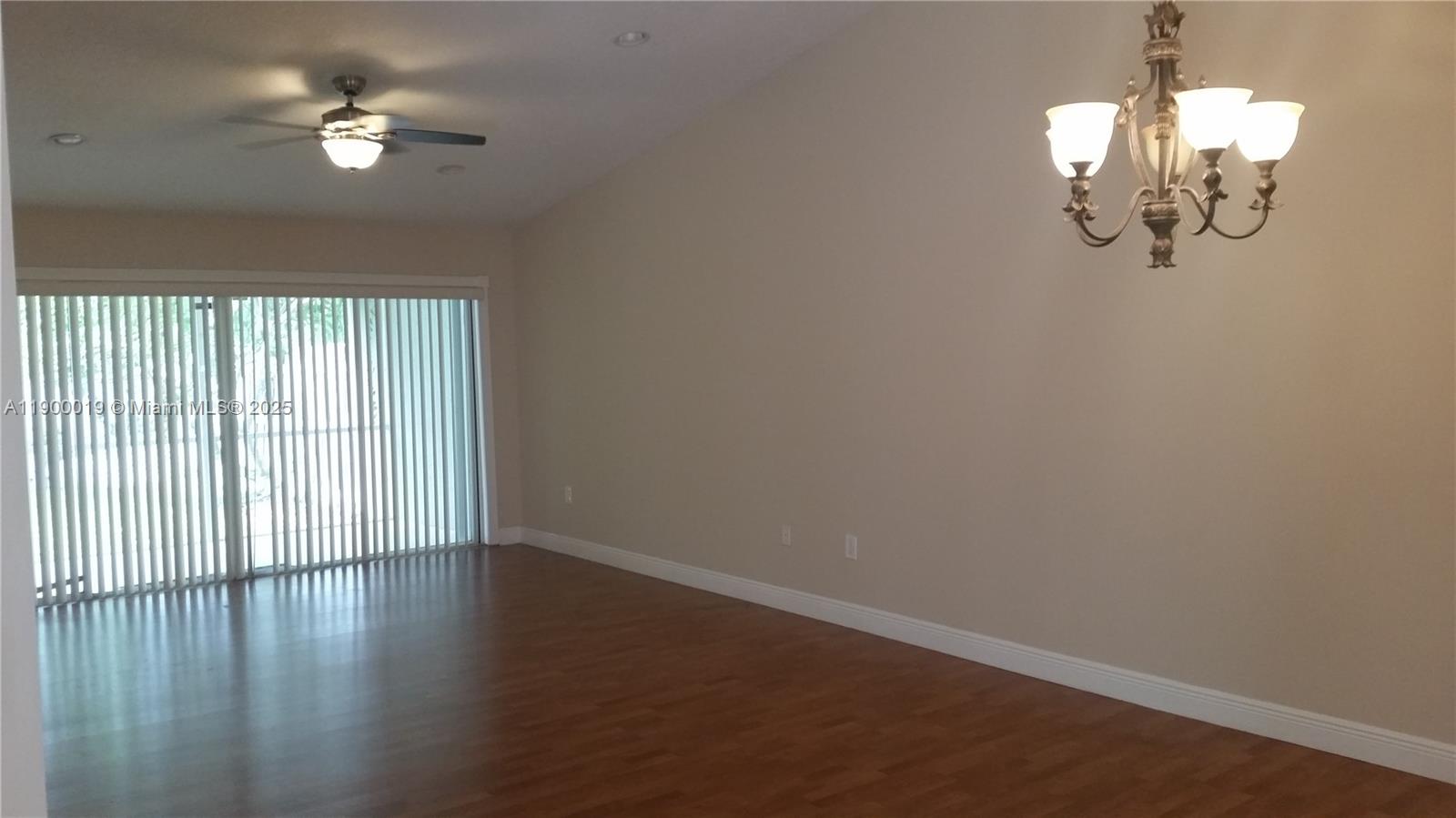 11071 Southwest 11th Place, Unit 124 Davie, FL 33324 - Photo 9 of 18 wooden floor in an empty room with a window