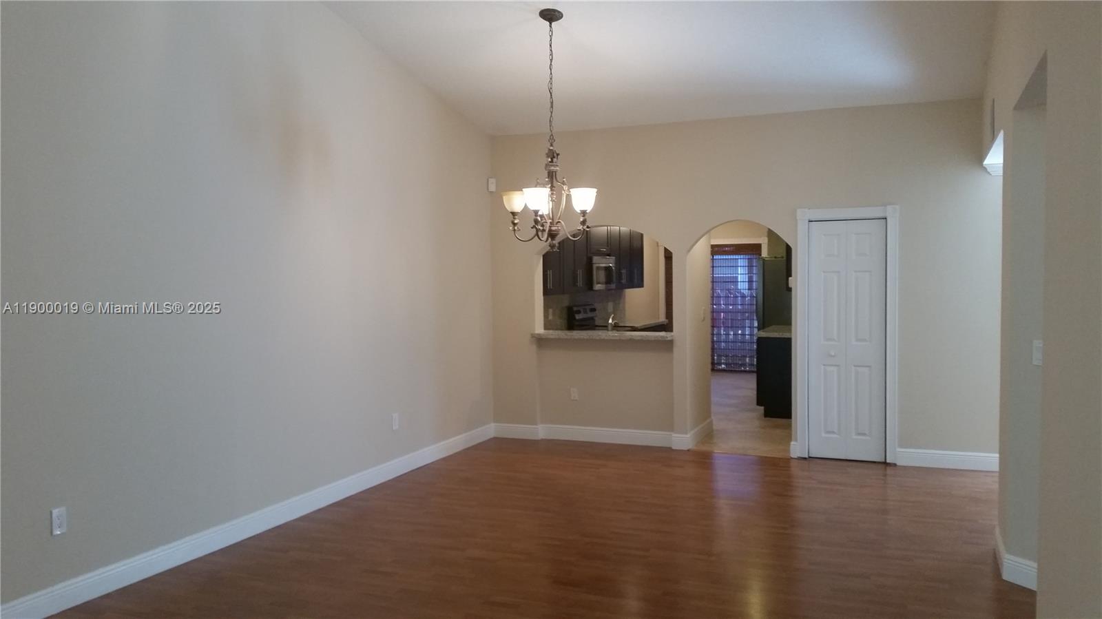 11071 Southwest 11th Place, Unit 124 Davie, FL 33324 - Photo 10 of 18 a view of a room with window and wooden floor