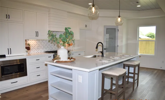 a kitchen with a sink cabinets and microwave