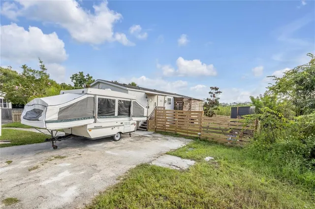a view of a house with a yard and sitting area