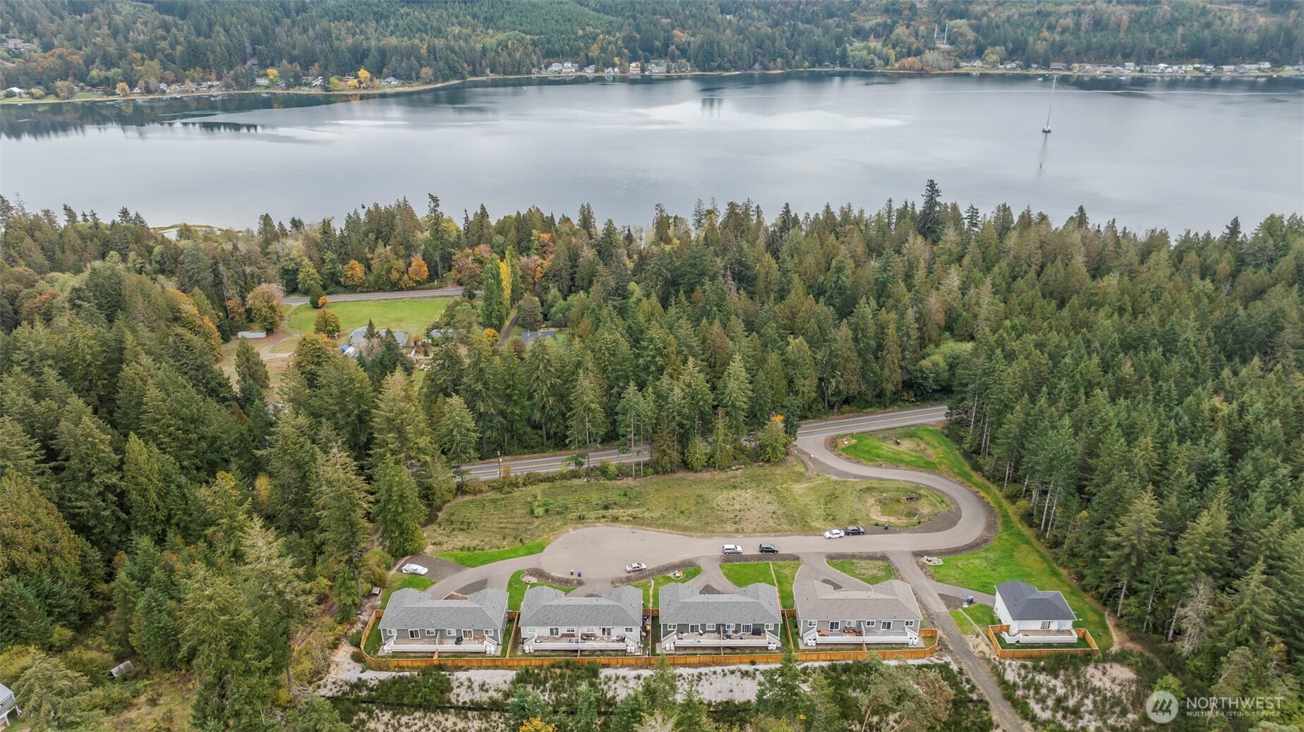 19019 Highway 3, Unit A Allyn, WA 98524 - Photo 2 of 22 a view of a lake with a yard and mountain view