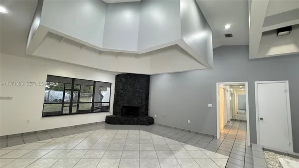 a bathroom with a granite countertop sink a mirror and a bathtub